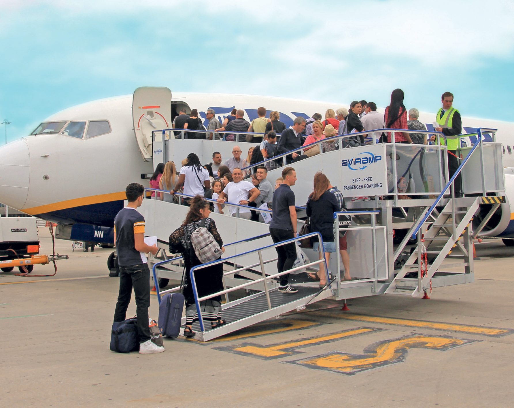 This step-free boarding setup showcases a thoughtful approach to inclusive travel, ensuring that passengers with mobility aids, strollers, or heavy luggage can board the aircraft comfortably and safely without the need for stairs or lifts. The ramp is constructed with smooth, non-slip surfaces and sturdy handrails on either side, providing stability and confidence for all users. Its wide design accommodates various mobility devices, such as wheelchairs and walkers, seamlessly integrating accessibility into the boarding process. The clear signage and organized layout demonstrate the airport’s commitment to universal design principles, making air travel accessible for everyone regardless of physical ability. Passengers appear relaxed and confident as they walk onto the aircraft, highlighting a positive and welcoming travel environment. This kind of infrastructure not only enhances passenger experience but also promotes greater independence and dignity for travellers with disabilities or limited mobility. Overall, it’s a great example of how airports and airlines are prioritizing inclusivity in modern aviation.