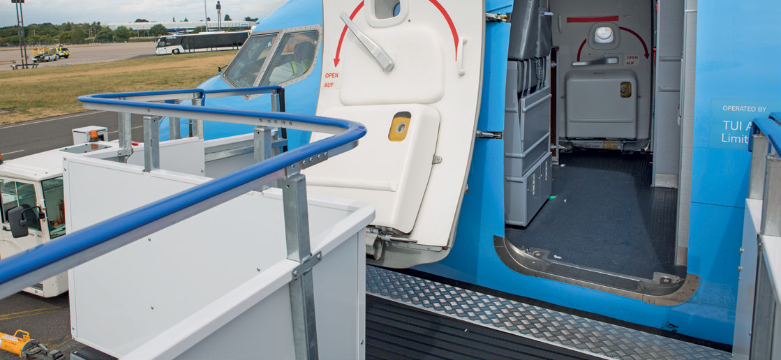 This scene offers a fascinating glimpse into the behind-the-scenes world of aviation. The cockpit door, prominently labelled with "OPEN" and "AUF" (German for "up" or "open"), signifies a moment of transition—either preparing for boarding, crew entry, or final checks before take-off. The clear, well-maintained appearance of the aircraft’s exterior reflects the high standards of safety and professionalism upheld by airlines and ground crews worldwide. The surrounding environment, with ground support vehicles and a bus in the background, hints at the bustling activity that keeps the airport running smoothly. These vehicles transport crew, luggage, or maintenance supplies, all essential for a seamless flight experience. The scene also emphasizes the international nature of air travel—German signage alongside universal safety cues—highlighting how airports are vibrant hubs of multicultural exchange. This snapshot captures the anticipation and precision involved in aviation operations—the meticulous checks, teamwork, and technology that ensure passengers arrive safely at their destinations. It’s a moment filled with potential, adventure, and the promise of new journeys. Truly fascinating and awe-inspiring!