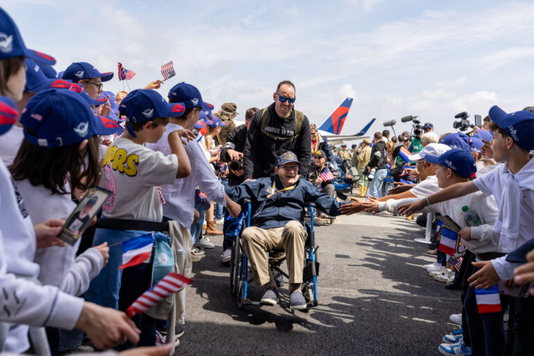 Welcome home! Celebrating with cheers and cheers as a hero returns, greeted by excited fans and loved ones at the airport.