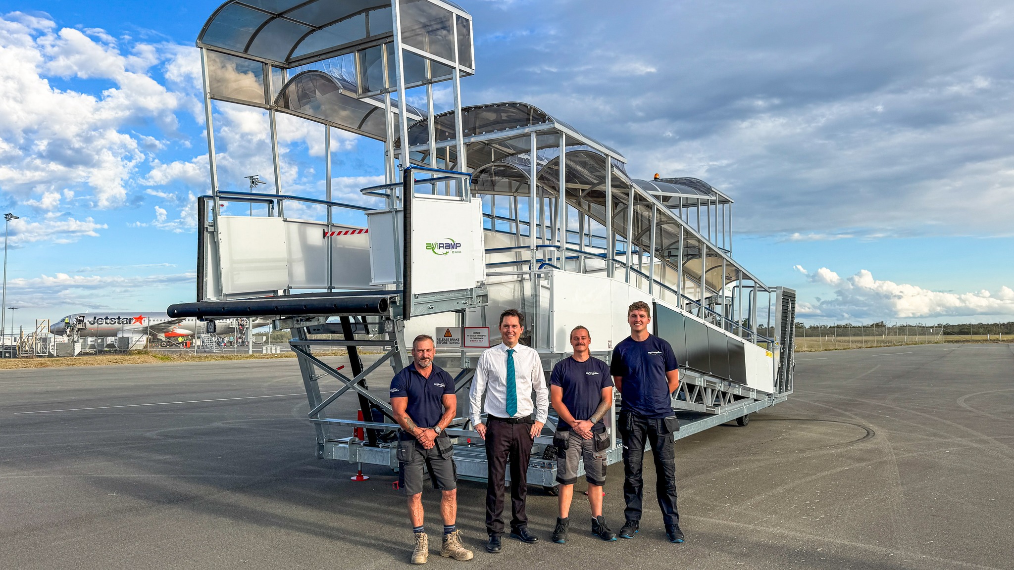 The installation team from Aviramp standing in front of the most recent step free boarding ramp at Hervey Bay Airport