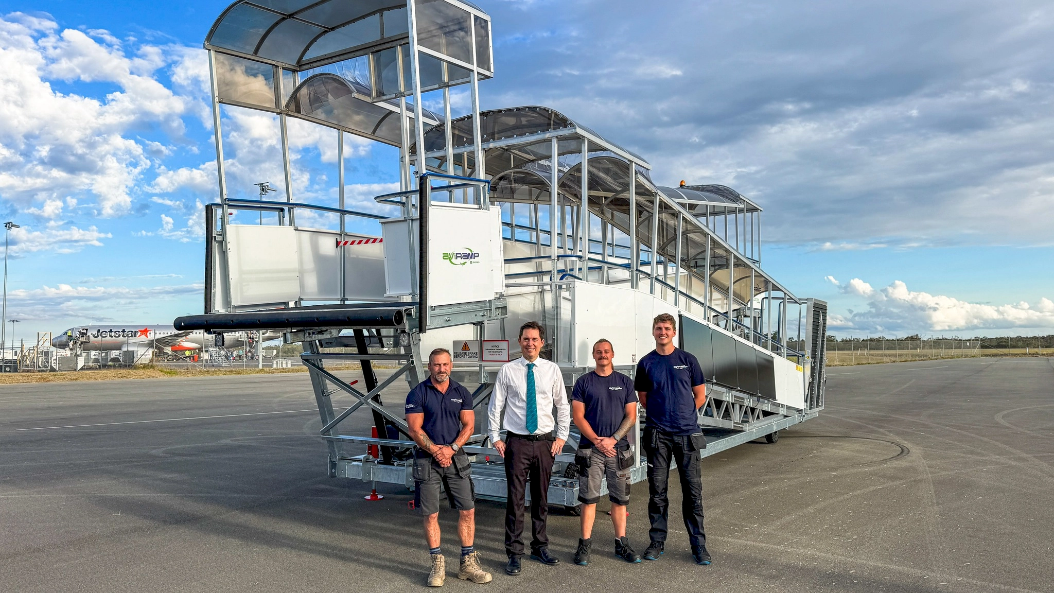 The installation team from Aviramp standing in front of the most recent step free boarding ramp at Hervey Bay Airport